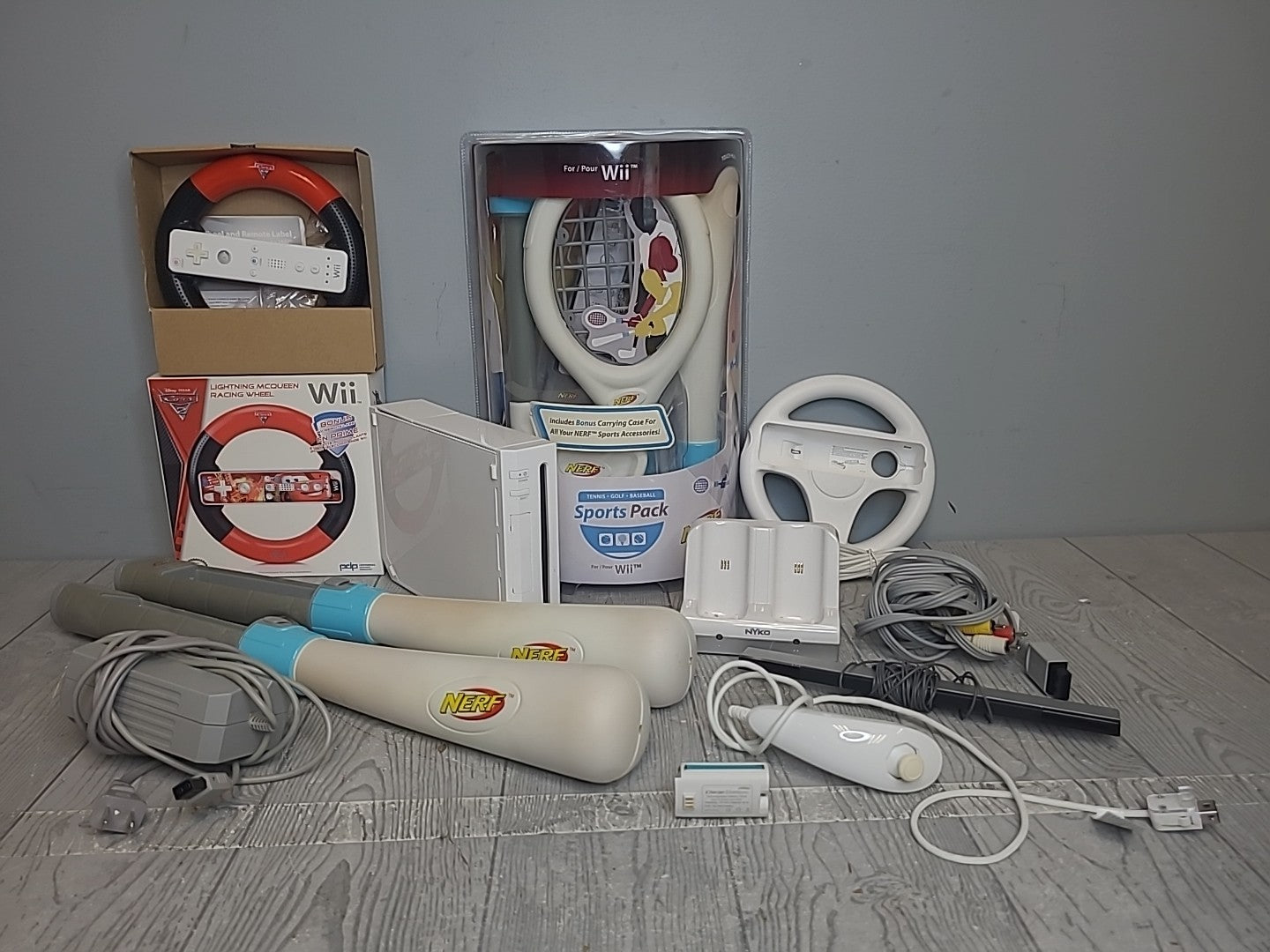 Nintendo Wii Lot White Console, Nerf Sports Pack, Cars 2 Wheel, and Misc Items