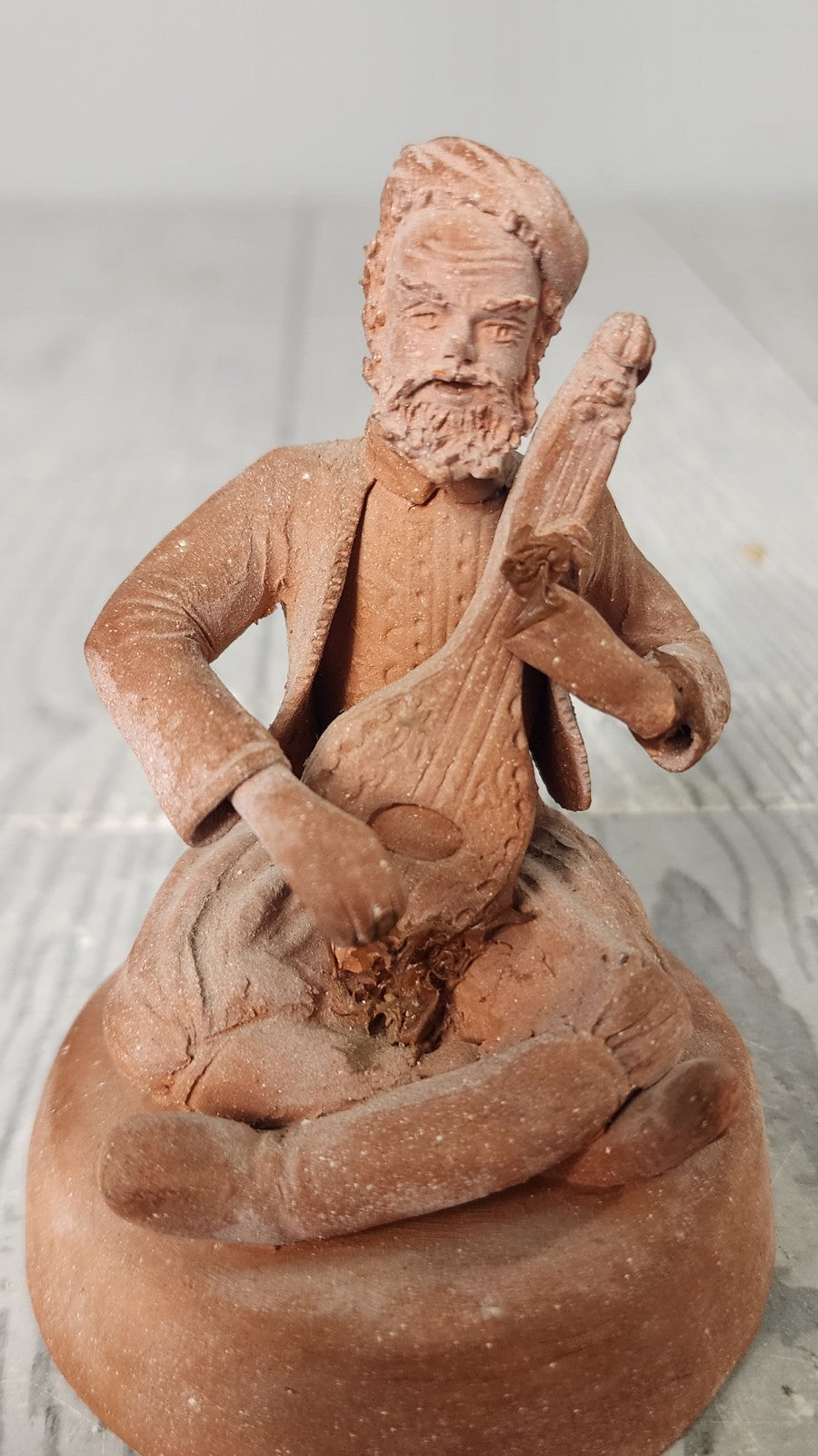 Hand Made Terracotta Sculpture of a Seated Man Playing Stringed Instrument Si