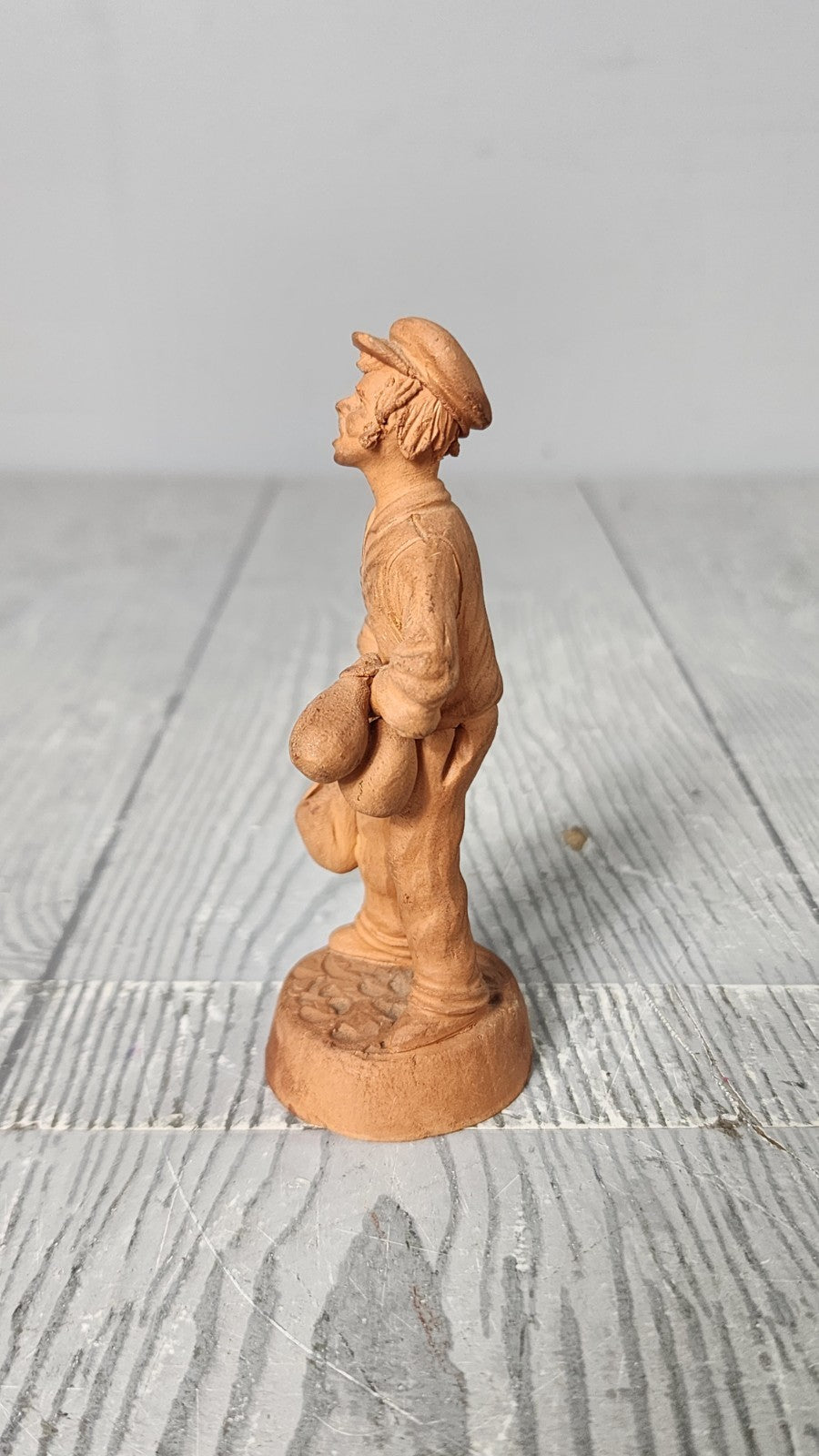 Vintage 5" Hand Made Terracotta Sculpture of a Man wt Bags in His Hands Unsigned