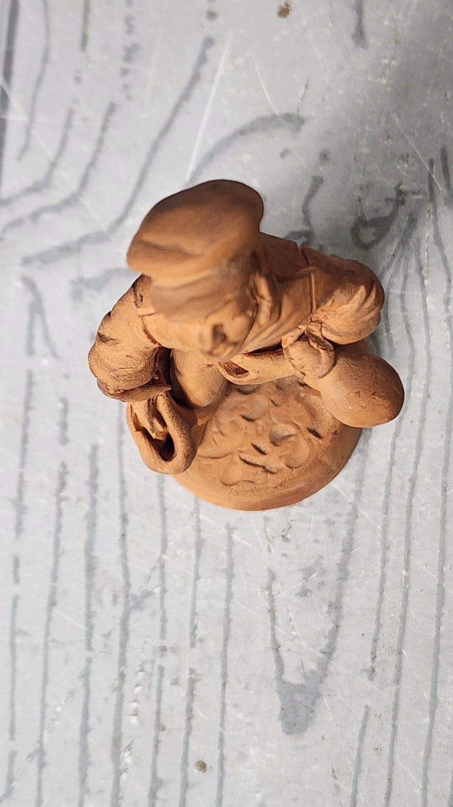 Vintage 5" Hand Made Terracotta Sculpture of a Man wt Bags in His Hands Unsigned