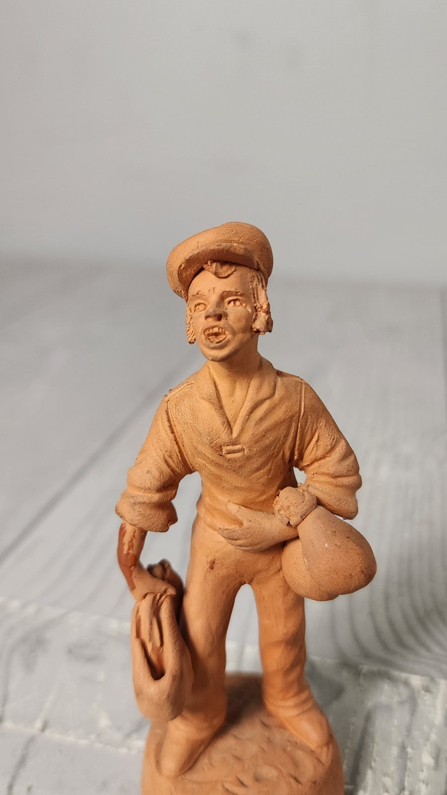 Vintage 5" Hand Made Terracotta Sculpture of a Man wt Bags in His Hands Unsigned